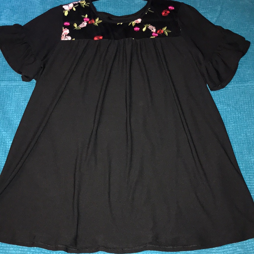 Black top with sheer floral inset